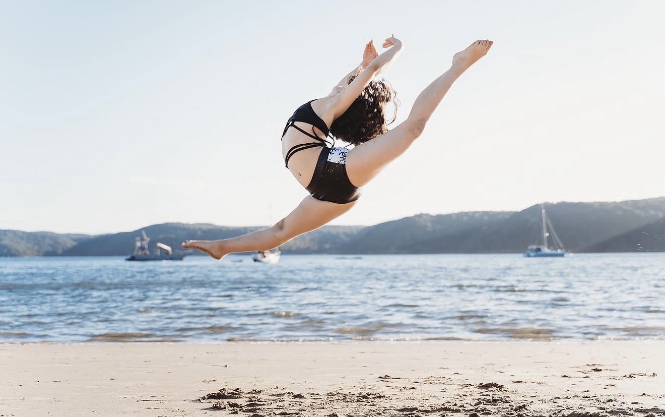 Bianca Papa performing a leap by the water