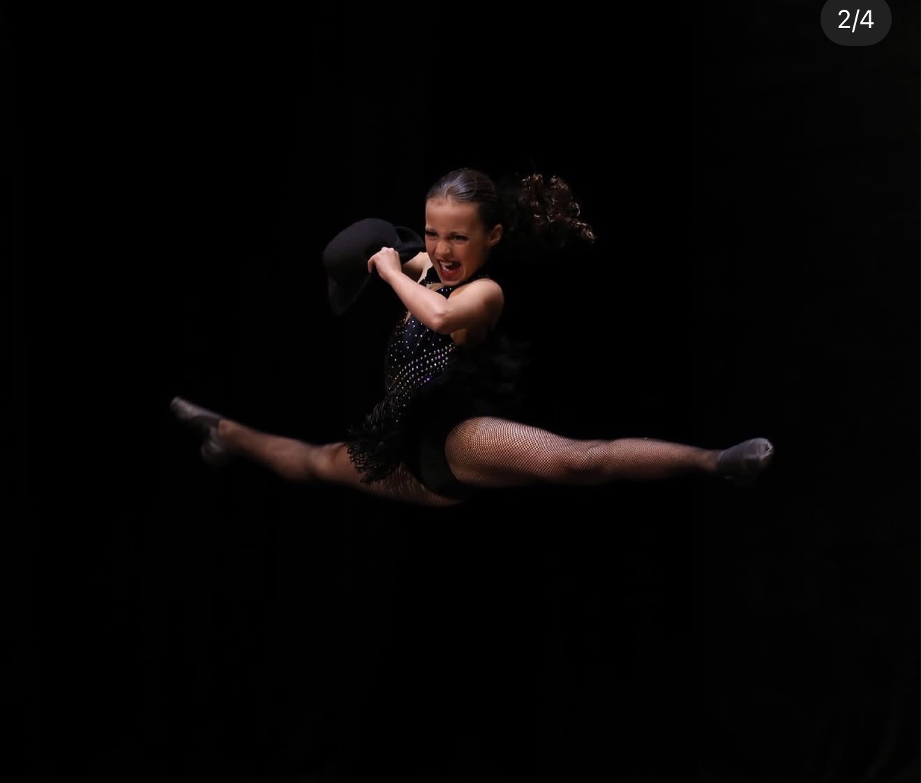 Bianca Papa in a split leap on stage