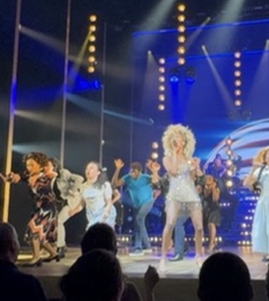 Bianca Papa on stage with the TINA company